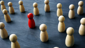 Uniqueness and differentness concept. Be unique. Wooden figures on a table.