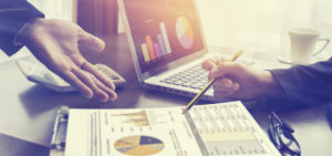 New startup business project,Business meeting time,account managers crew working with new startup project,pointing hands,Laptop Notebook on wood table.analyze plans,vintage tone,morning light flare